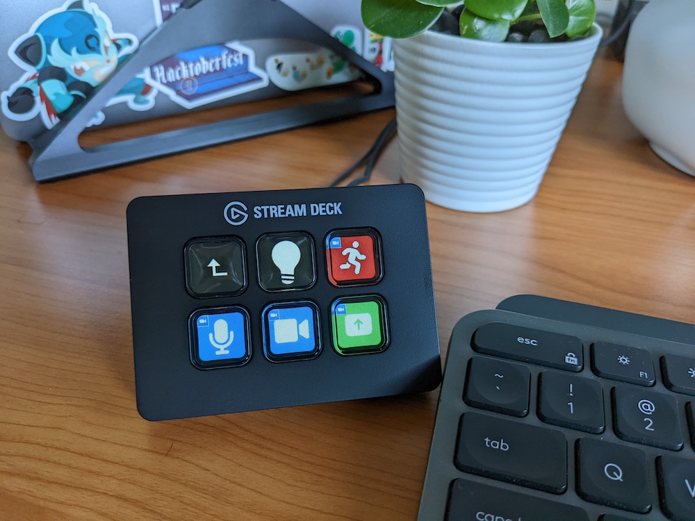 Steam deck mini on a desk next to a keyboard